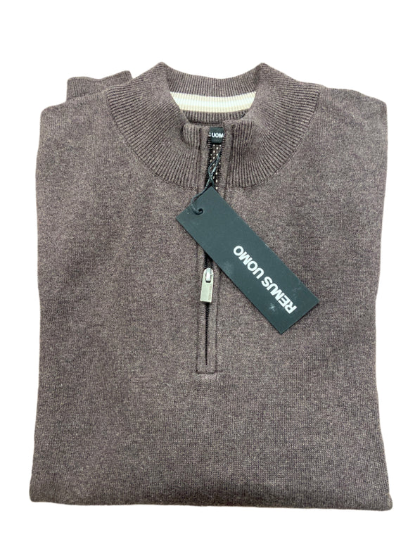 Folded gray sweater with a brand tag on a wooden surface